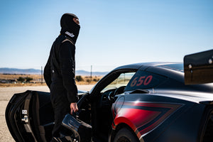 Man Getting in Car Wearing Black Head Sock