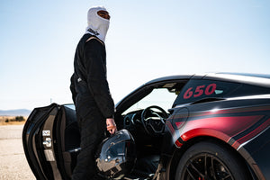 Man Getting in Car Wearing White Head Sock